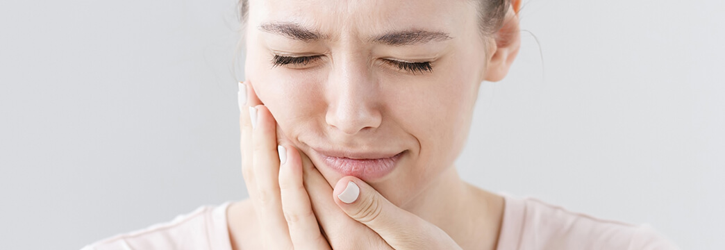 Woman Holding Her Jaw in Pain Emergency Dentist Richmond TX